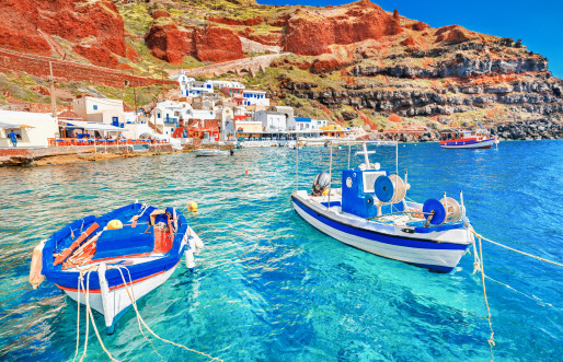 Two blue and white boats in an ocean cove